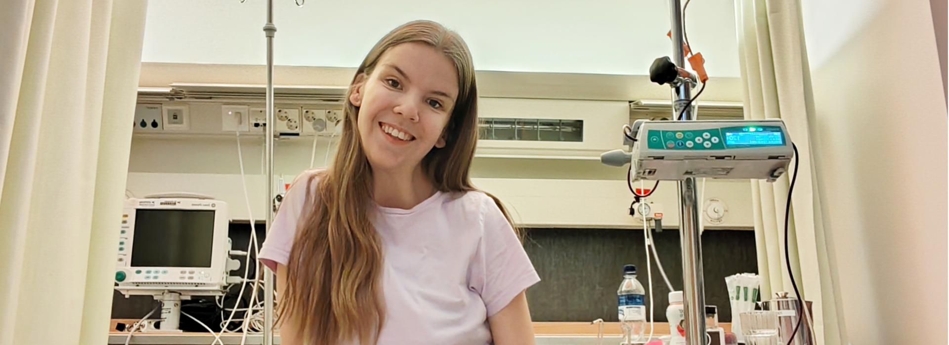 Elli Malinen sitting on the bed in hospital.