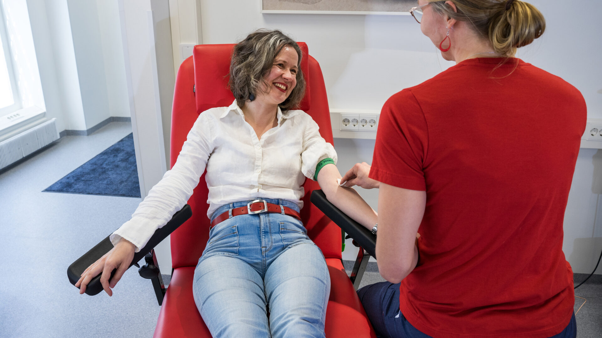 A woman is donating blood at blood donation site