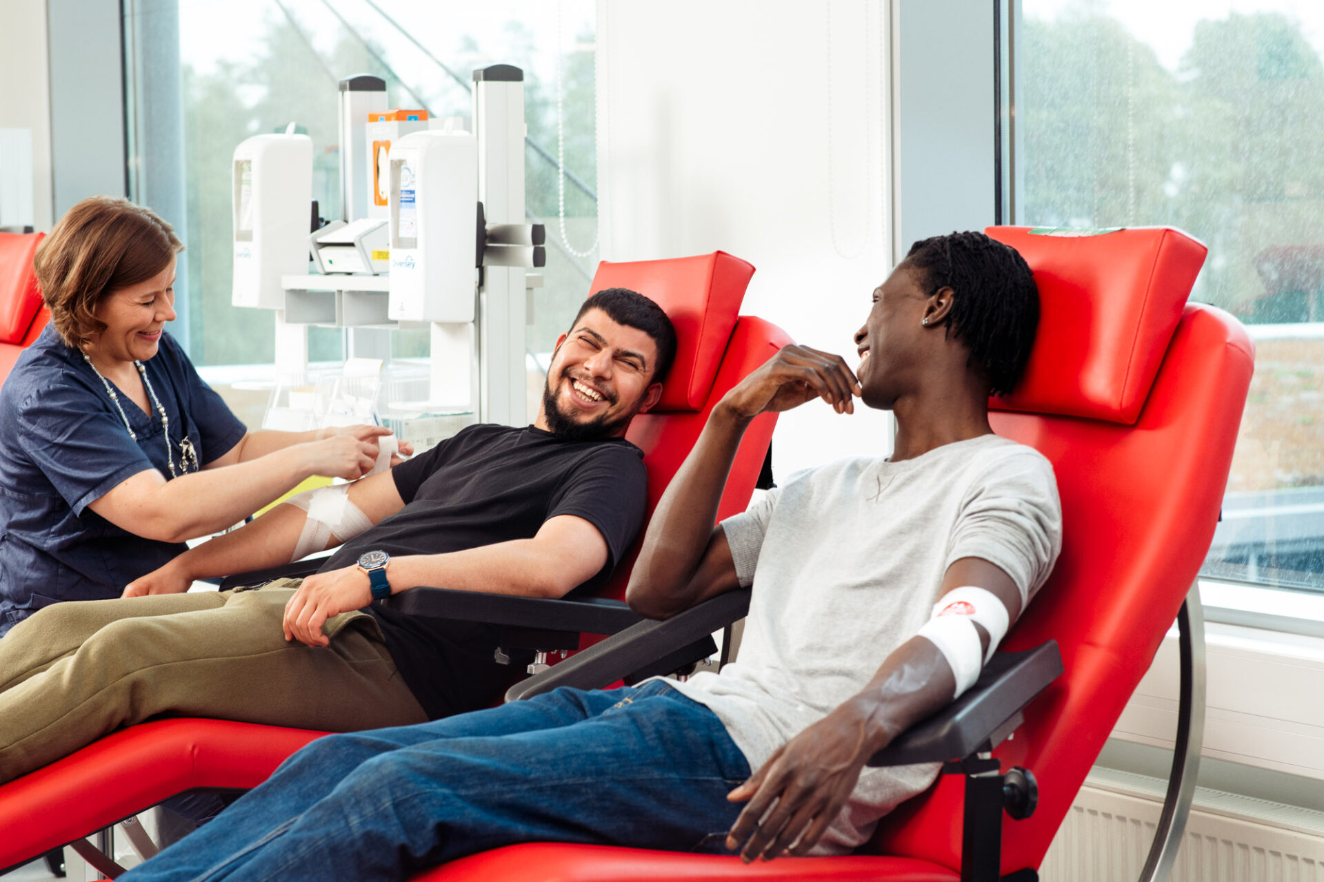 Two men donating blood.