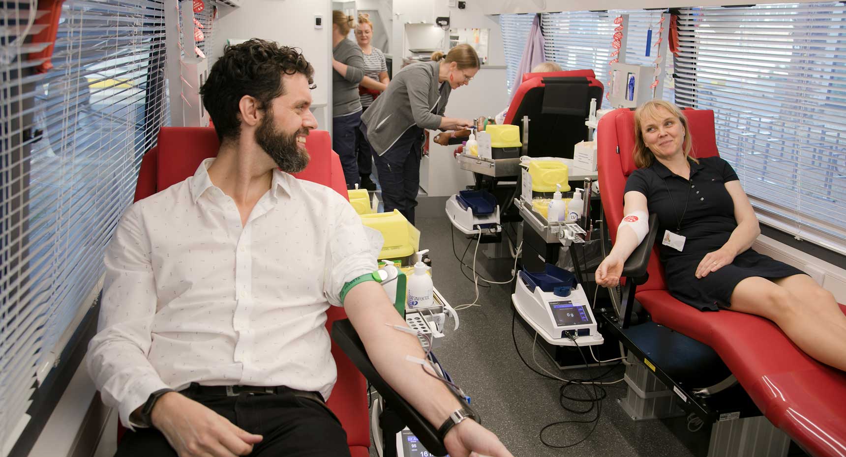 ECHA personnel donating blood in Blood donation bus.